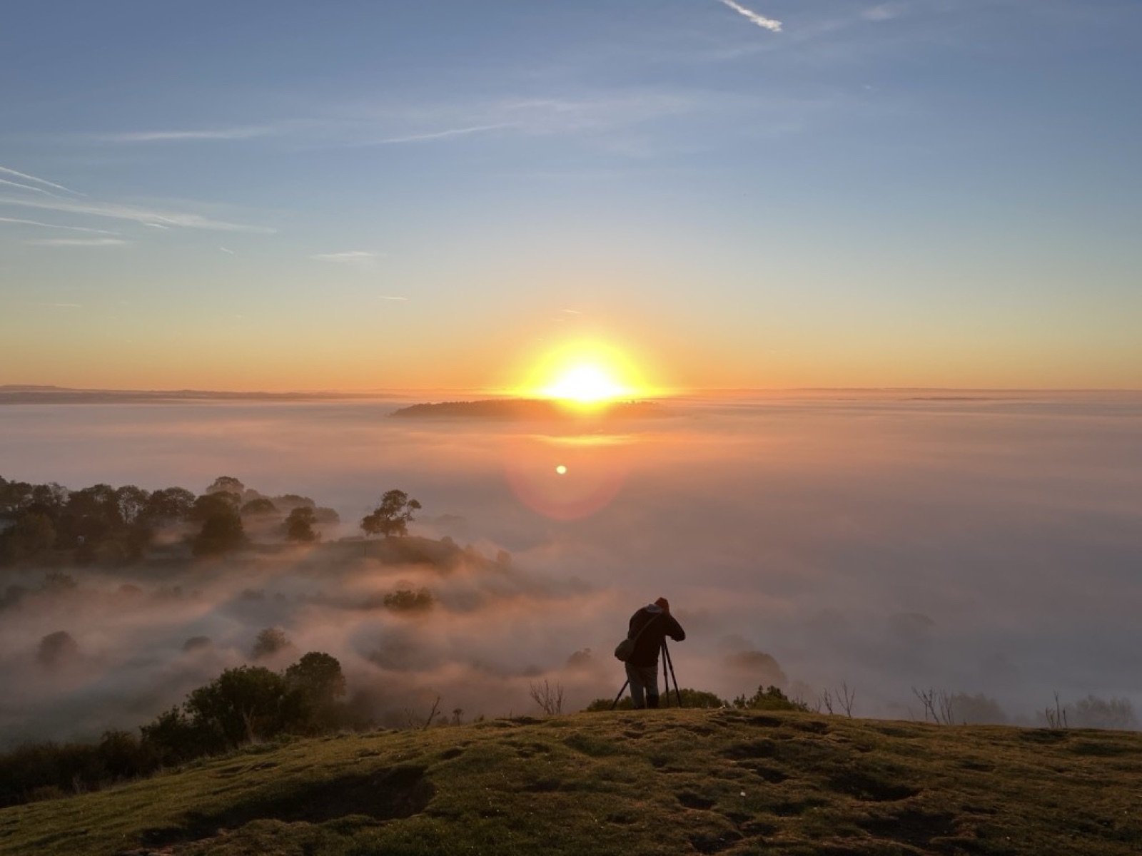 Sunrise over the mist from a sacred hilltop
